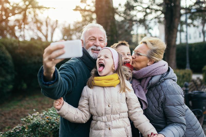 banner grandparents taking selfie with grandchildren